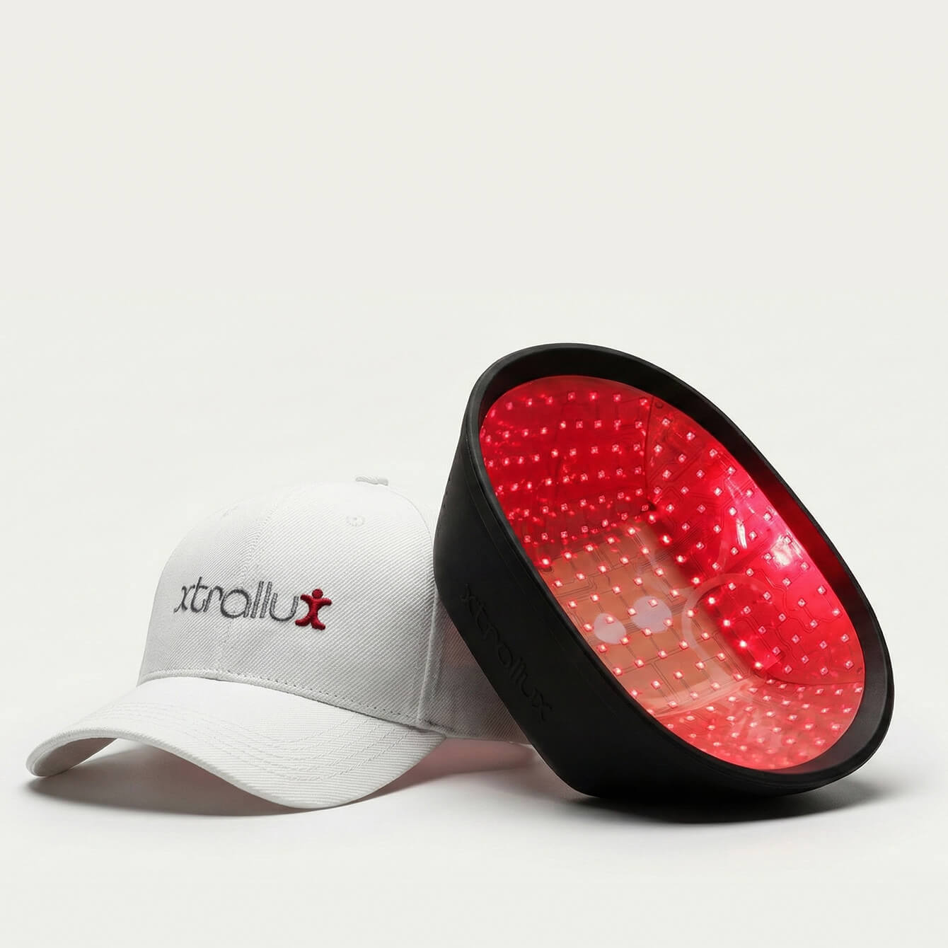 White cap with 'xtrallux' logo and black LED headlamp on a white background